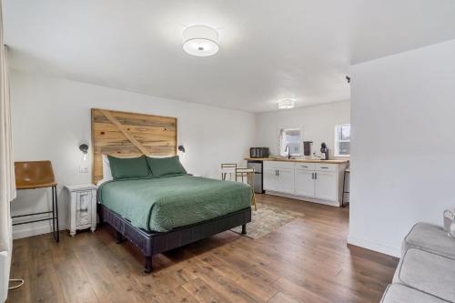 a bedroom with a bed and a kitchen at Selkirk Motel in Colville