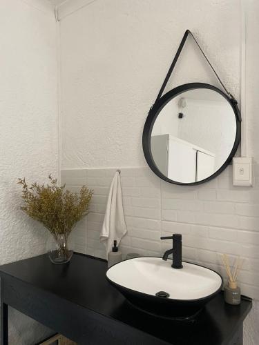 a bathroom with a sink and a mirror at Groenewald's Haven in Nelspruit
