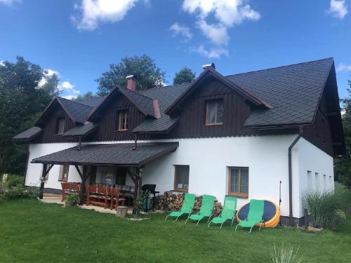 a group of chairs sitting in front of a house at Penzion Terezka in Králíky