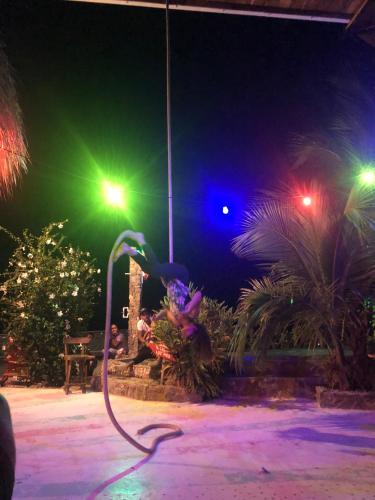 a lit up room with a water hose at night at Puerto Alto Hostel in Santa Marta