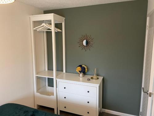 a white cabinet with a dresser in a room at The Uxbridge Suite in Hednesford