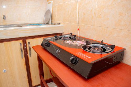 a stove sitting on a counter in a kitchen at The Nest Studio Apartment in Bamburi Mombasa in Mombasa