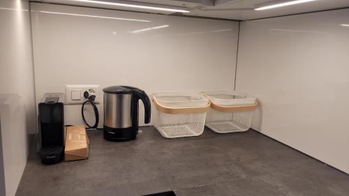 a room with a coffee maker and two baskets at Chalet Meise in Obergesteln