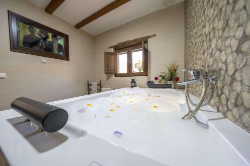 a large bathroom with a tub with a shower at romantic house for 2 or 4 people with jacuzzi in Laroya