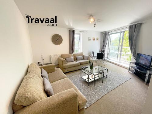 a living room with a couch and a table at Travaal.©om - 2 Bedroom Apartment - Basingstoke in Basingstoke
