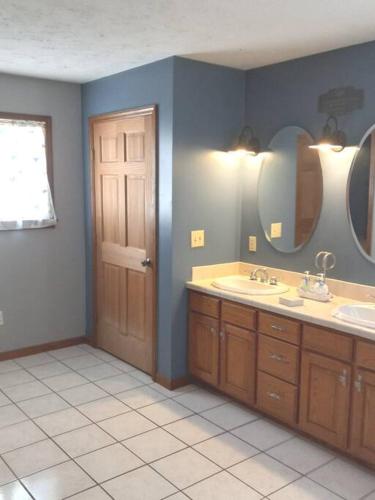 a bathroom with two sinks and two mirrors at Tug Hill Paradise, Copenhagen, NY in Copenhagen