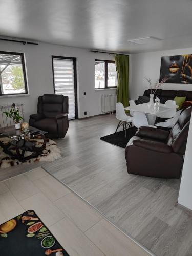 a living room with a couch and a table at VILA RAISA in Neagra Şarului