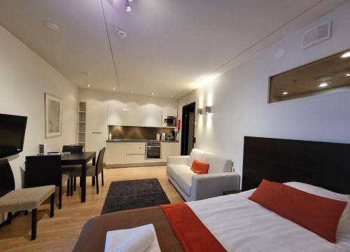 a hotel room with a bed and a dining room at Levi Suites Levi Gold in Levi