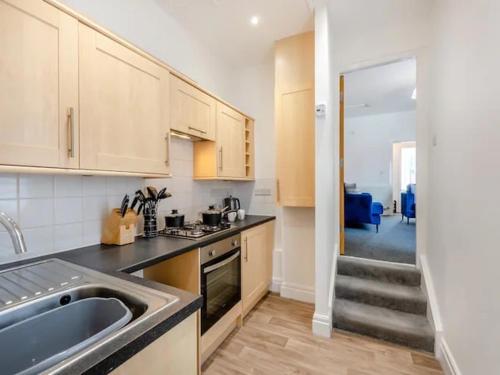 a kitchen with a sink and a counter top at Charles Alexander Short Stay - Clifton House Apartment in Lytham St Annes