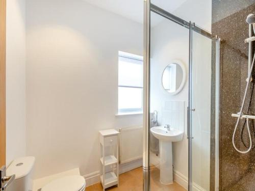 a bathroom with a shower and a toilet and a sink at Charles Alexander Short Stay - Clifton House Apartment in Lytham St Annes