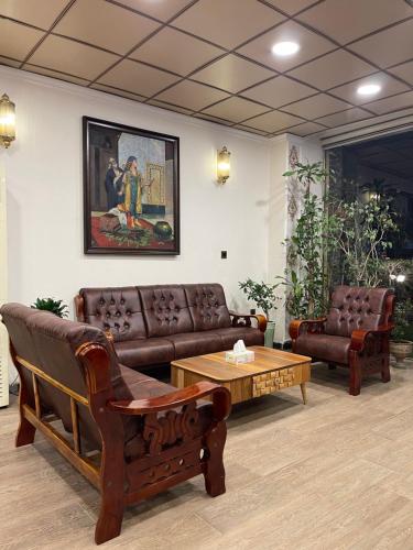 a living room with couches and a coffee table at Al-Rabie Hotel & Apartments in Baghdad