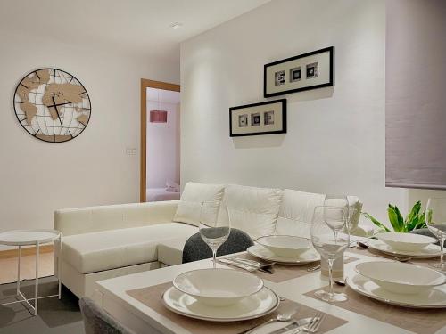 a living room with a table with plates and wine glasses at Carte du Monde by ARoom VUT-LE-967 in León