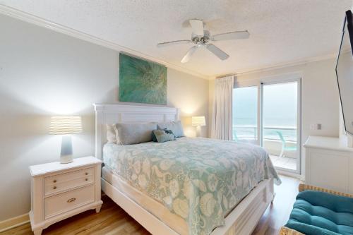 a bedroom with a bed with a view of the ocean at Enclave 304 in Orange Beach