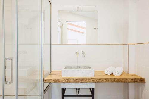 a bathroom with a sink and a shower at Boutique Suites 186 in Sorrento