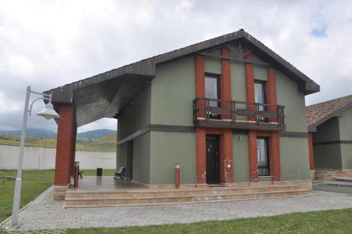 a house with a balcony on the side of it at Arena Hotel Goygol in Xanlar