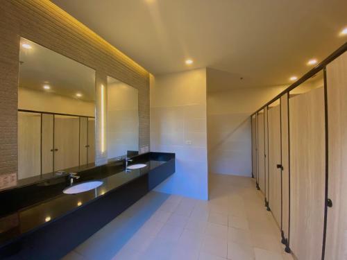 a bathroom with two sinks and a large mirror at Condo • WIFI up to 100mbps • Pool • Netflix&Chill in Cebu City