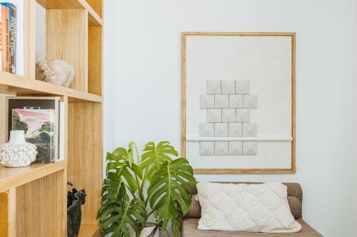a living room with a couch and a plant at Boutique Suites 186 in Sorrento