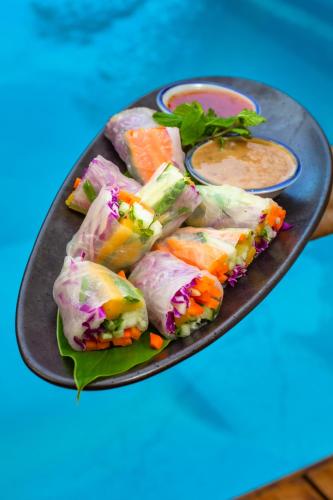 a plate of food on a blue table at The Lodge at Punta Rica- Hilltop Eco-Lodge with Views & Pool in Bastimentos