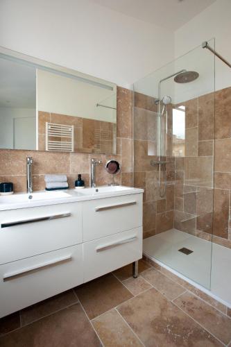 une salle de bain avec un lavabo et une douche dans l'établissement Appartement avec terrasse, à Libourne