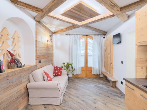 ein Wohnzimmer mit einem weißen Sofa und Holzdecken in der Unterkunft CESA MARIN in Campitello di Fassa