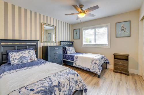 a bedroom with two beds and a ceiling fan at 2 Blocks to Riviera Beach Upscale Condo with Patio in West Palm Beach