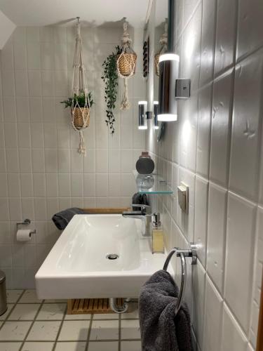a bathroom with a white sink in a room at The Vineyard View in Zell an der Mosel