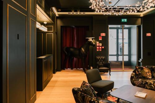a living room with a chair and a horse in it at Art Legacy Hotel Baixa-Chiado in Lisbon