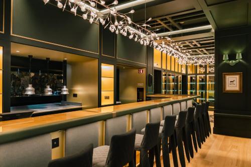 a bar with a row of chairs in a room at Art Legacy Hotel Baixa-Chiado in Lisbon