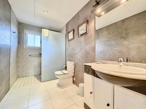 a bathroom with a sink and a toilet and a shower at Casa Rural Hípica Mas Paguina in L'Estartit