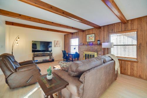 a living room with a couch and a tv at Adobe Home in Albuquerque with Covered Patio in Albuquerque