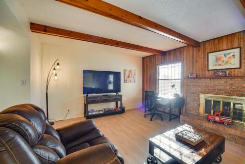 a living room with a couch and a fireplace at Adobe Home in Albuquerque with Covered Patio in Albuquerque