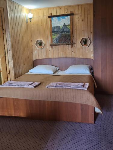 a bedroom with two beds in a wooden room at Fortuna in Lazeshchyna