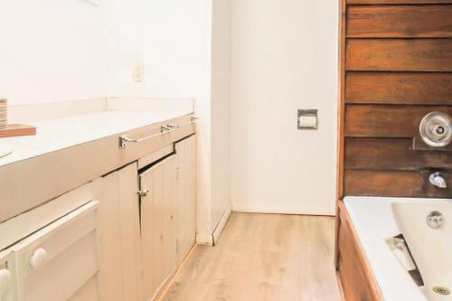 a kitchen with white counters and a wooden floor at Stark Mountain Sanctuary in Waitsfield