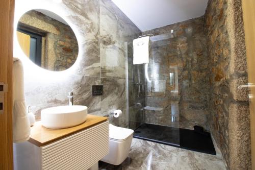 a bathroom with a sink and a shower at Quinta das Mirandas Nature in Oliveira de Frades