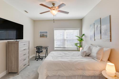 a bedroom with a bed and a ceiling fan at 3 Mi to Folly Beach Condo with Pool Access! in Charleston