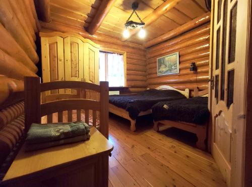 a room with two beds in a log cabin at Дерев'яний котедж "Казка" in Yaremche