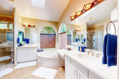 a bathroom with two sinks and a large mirror at Villa in the Sun in Phoenix