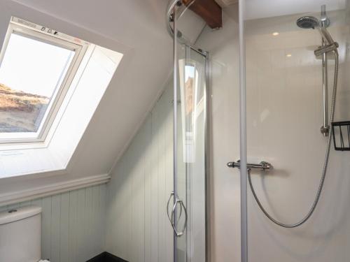 a bathroom with a shower and a window at Doune Bay Lodge in Mallaig