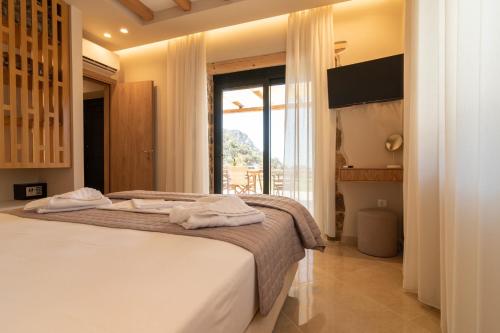 a bedroom with a bed with towels on it at Aoria Villas in Palaiochóra