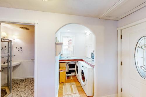 una cucina bianca con lavatrice e asciugatrice di Old Town Victorian a Steamboat Springs