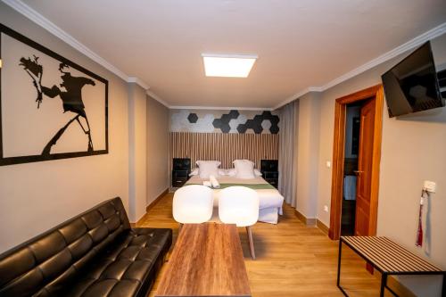 a hotel room with a bed and a couch at Hotel Monasterio Granada - Adults Only in Granada
