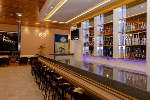 a bar with a row of chairs at a bar at DM Hoteles Tacna in Tacna