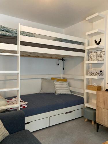a bedroom with bunk beds and a blue bed at Apartmán U Jelena in Jablonec nad Nisou