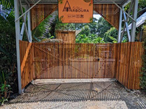 a gate in a building with a sign on it at Arboura Eco Cabins in Uvita