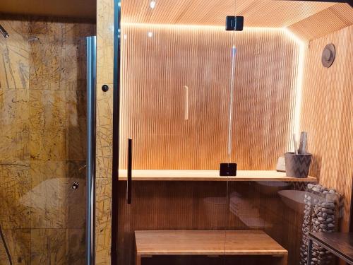 a bathroom with a wooden cabinet and a sink at Cisowy Zakątek in Sasino