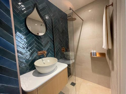 a bathroom with a sink and a glass shower at Villa Chiesa in Le Grau-du-Roi
