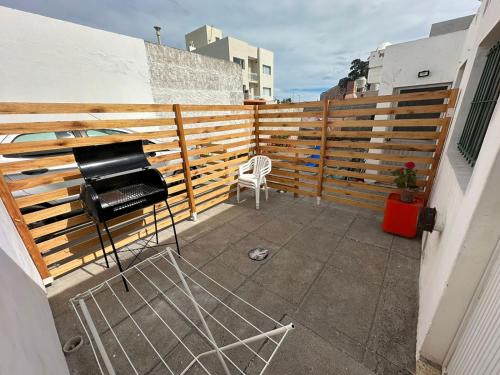 a patio with a grill and a chair on a balcony at La casa de Chola in Playa Unión