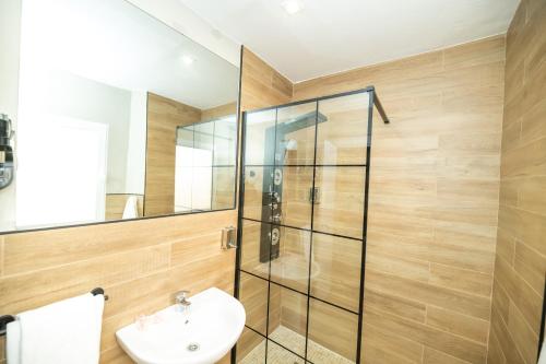 a bathroom with a glass shower and a sink at Hotel Monasterio Granada - Adults Only in Granada