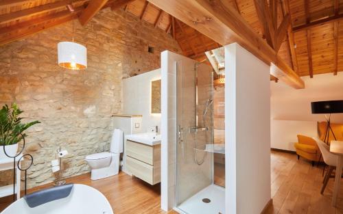 a bathroom with a shower and a toilet and a sink at The Fënnef in Bourglinster