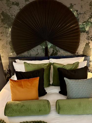 a bed with a bunch of pillows on it at Suite4SerenityRWY in Plymouth